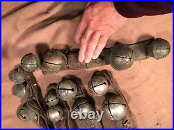 Lot H 5 strands of antique large brass sleigh bells on leather straps