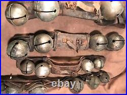 Lot H 5 strands of antique large brass sleigh bells on leather straps