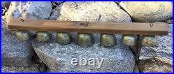 Set Of 7 Graduated Sleigh Bells W Triple Clappers Mounted On Wrought Iron Strap